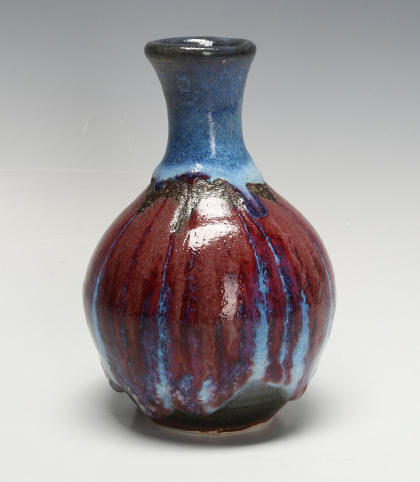 A GOOD HARDING BLACK BOTTLE VASE IN MULTI GLAZES