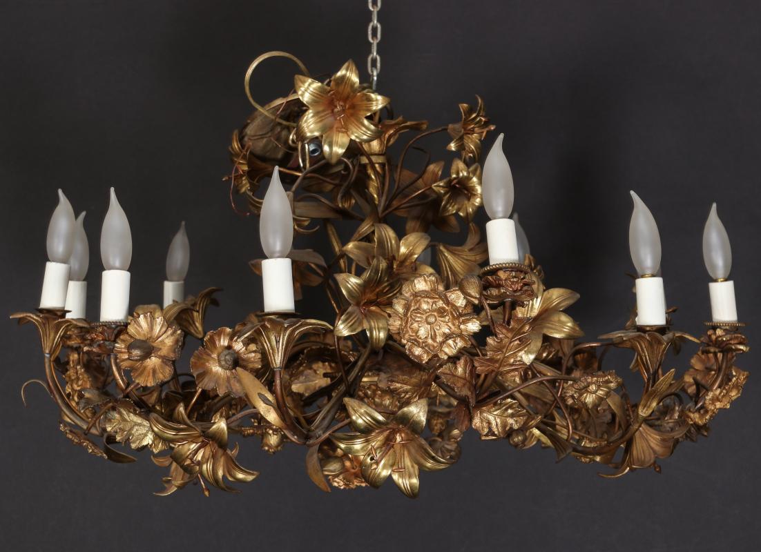 AN INTRICATE GILDED ANTIQUE FLORIFORM CHANDELIER