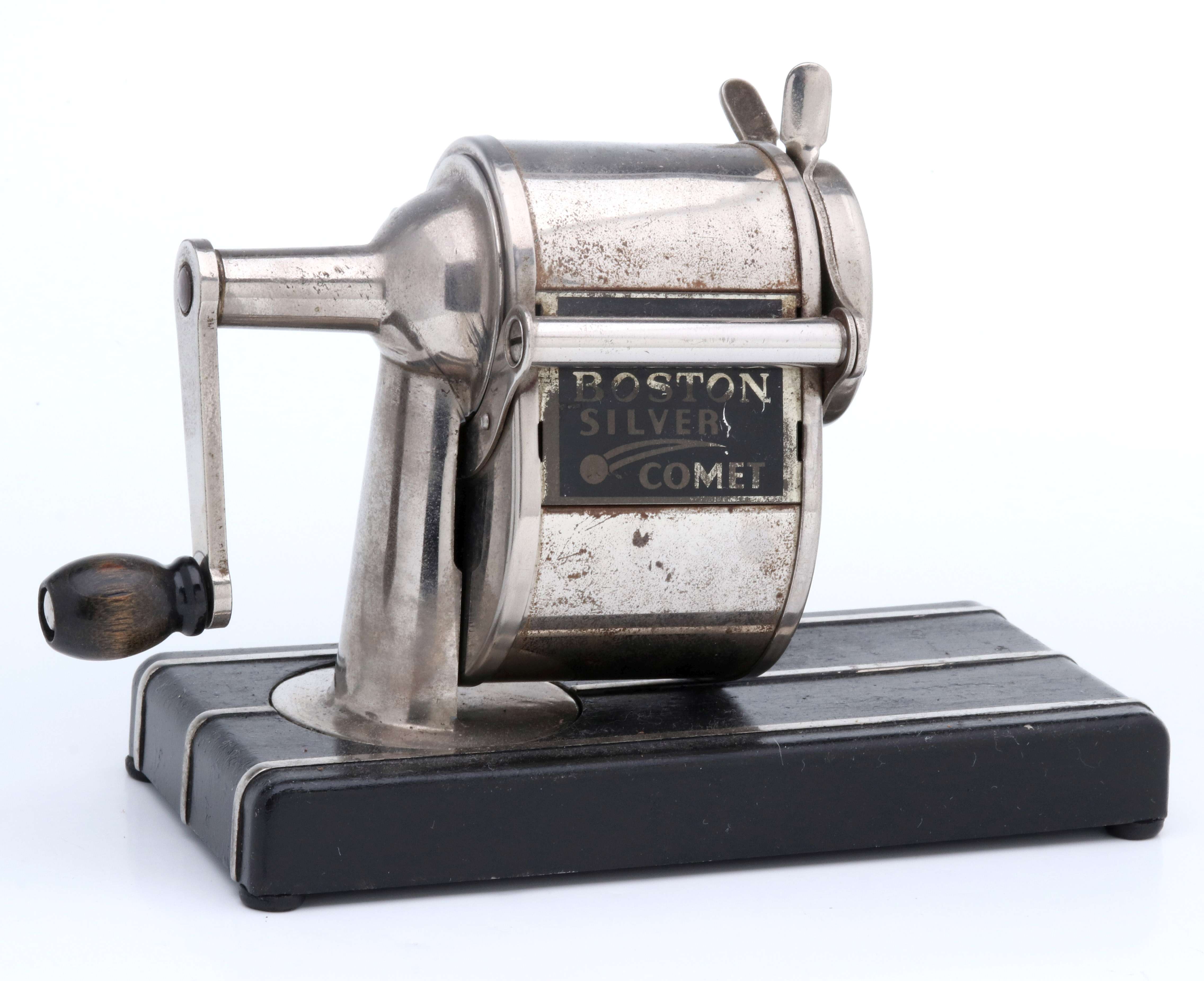 A BOSTON SILVER COMET MOUNTED PENCIL SHARPENER