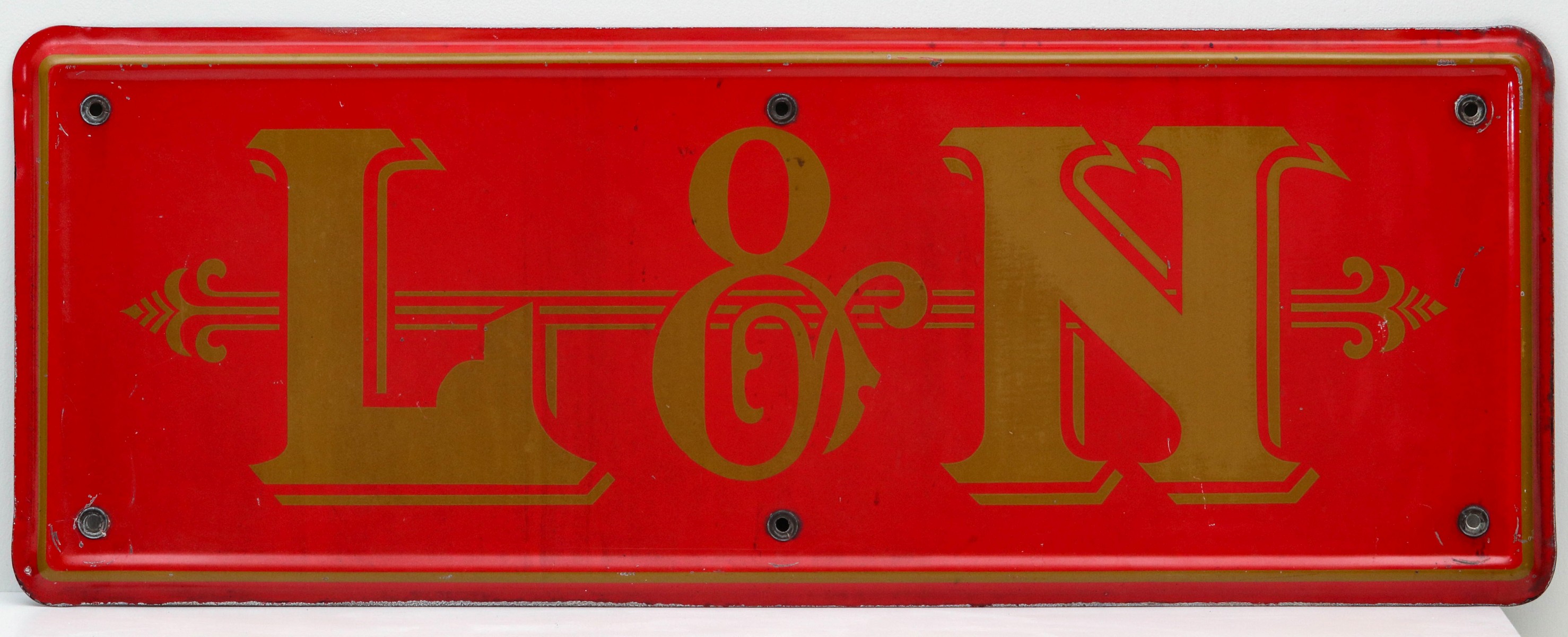 A GOOD PRESSED STEEL BADGE FOR LOUISVILLE NASHVILLE RR