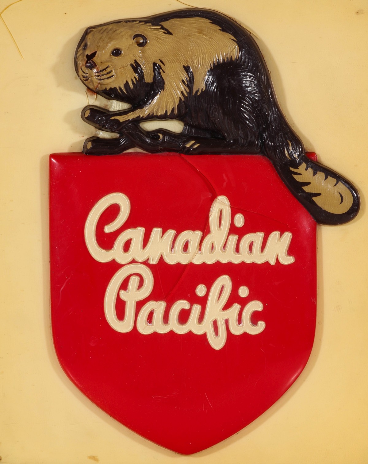 A MOLDED PLASTIC CANADIAN PACIFIC RAILROAD LOGO PLAQUE