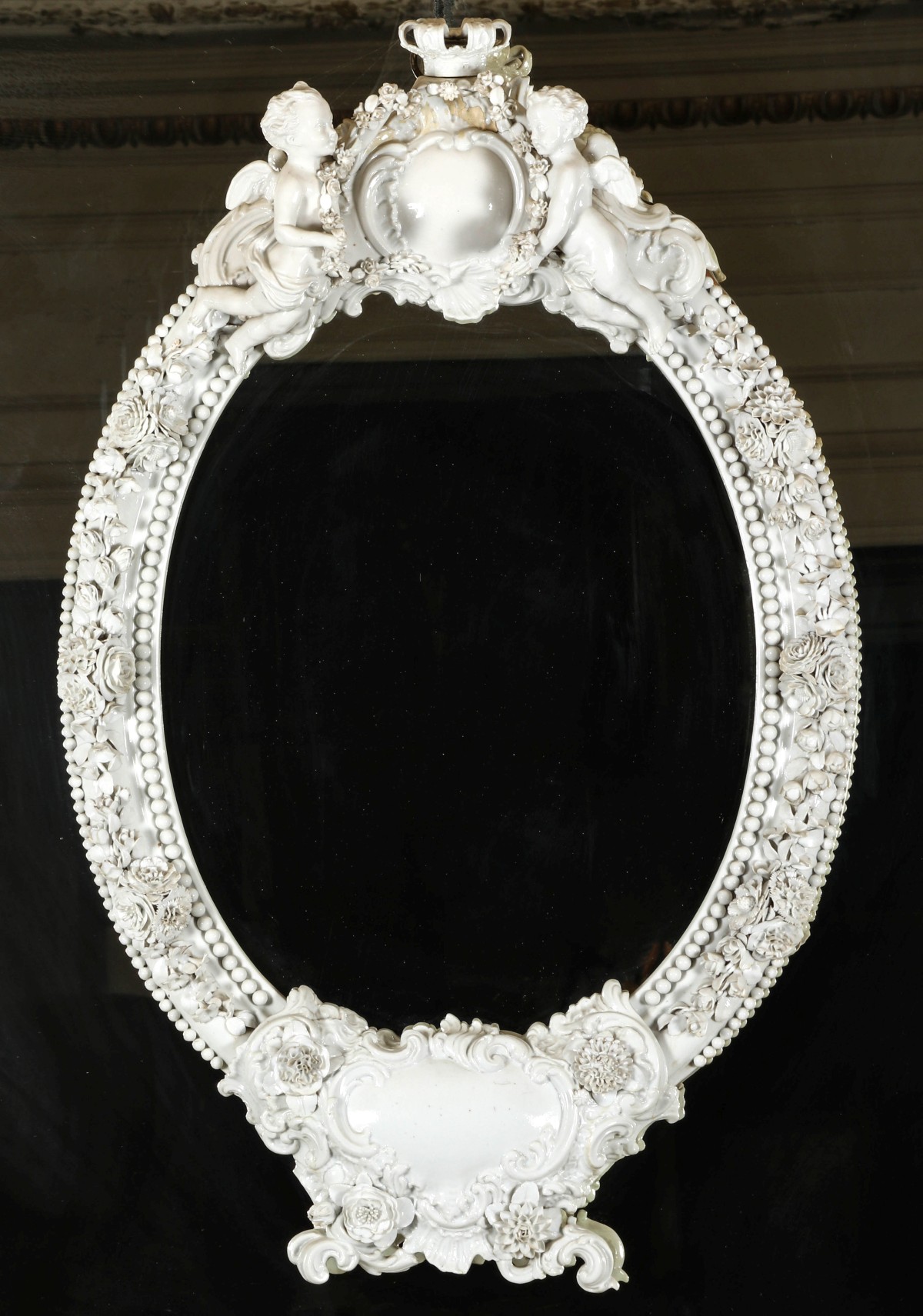 A LARGE 19TH C GERMAN PORCELAIN MIRROR WITH CHERUBS