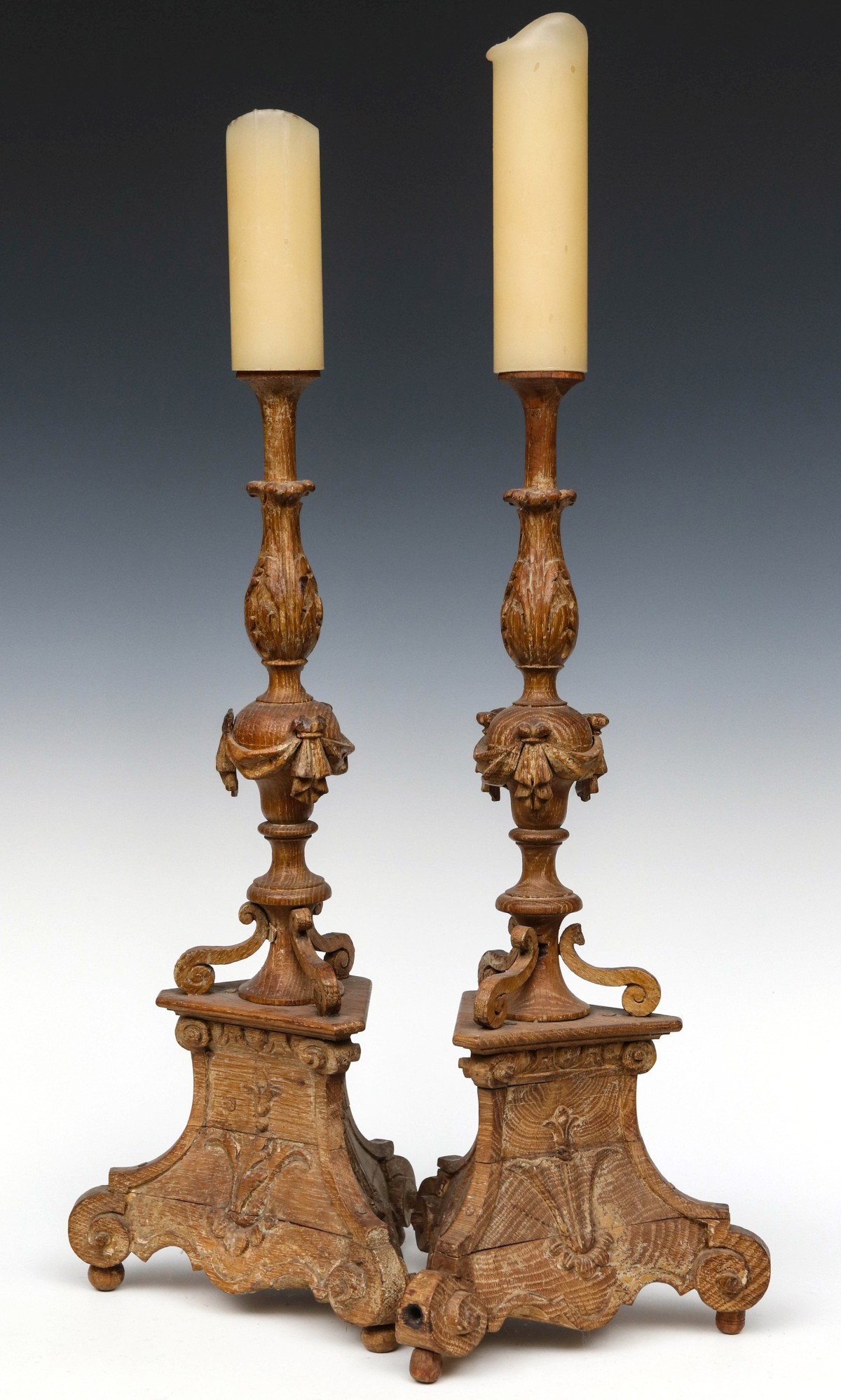 INTERESTING LOUIS XV PERIOD CARVED OAK CANDLESTICKS