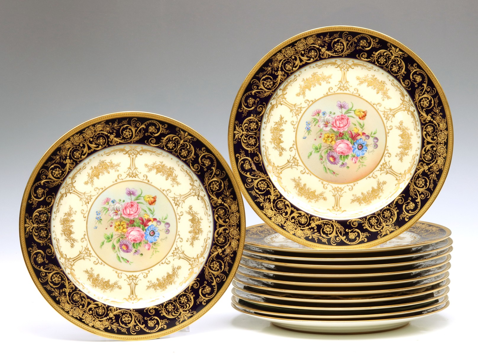 A SET OF TWELVE LIMOGES ARTIST SIGNED SERVICE PLATES