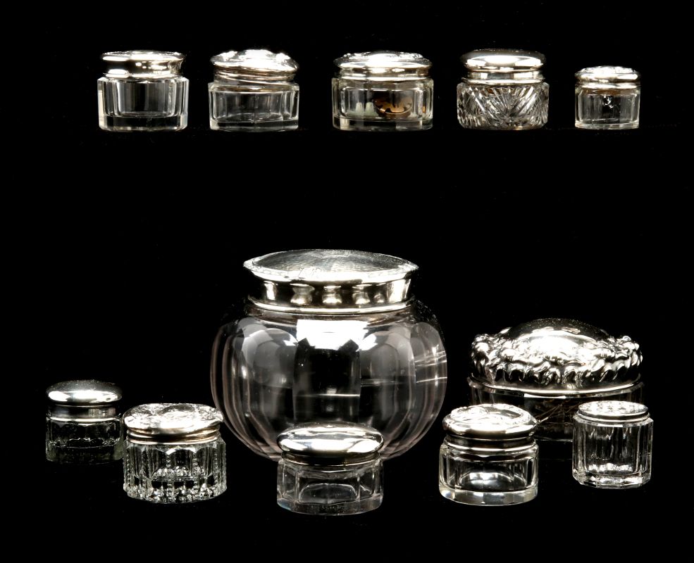 TWELVE STERLING SILVER TOPPED DRESSER JARS