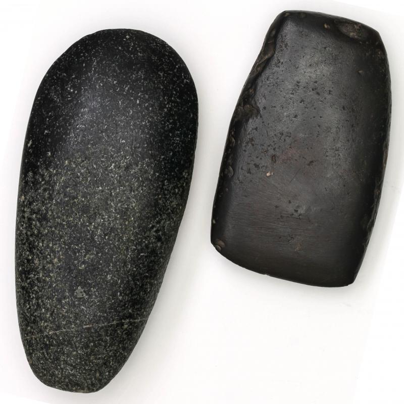 A HEMATITE CELT AND A STONE CELT