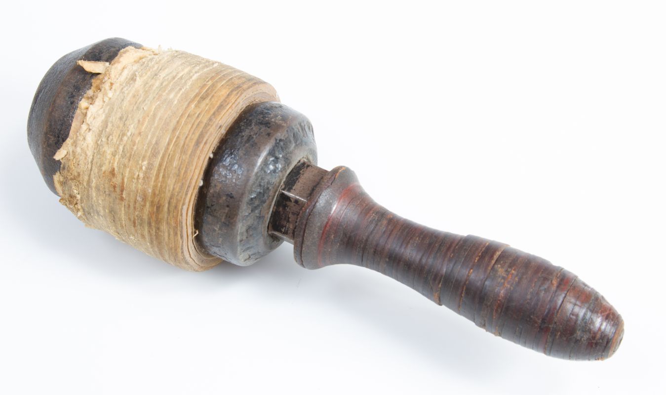 AN ANTIQUE RAWHIDE STONE CUTTER'S MAUL