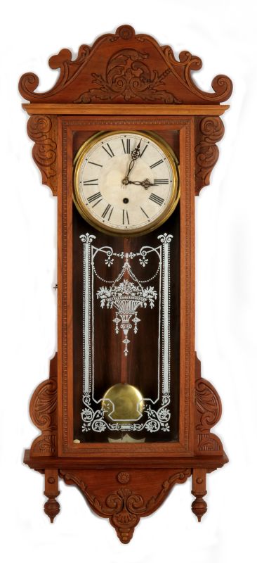 A WATERBURY 'ALTON' CARVED WALNUT WALL REGULATOR