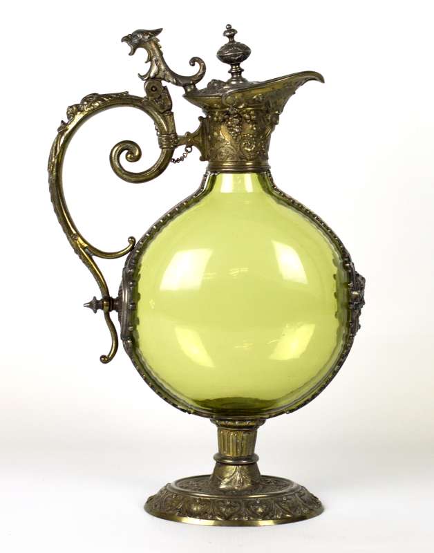 A CIRCA 1900 CONTINENTAL METAL MOUNTED CLARET JUG 