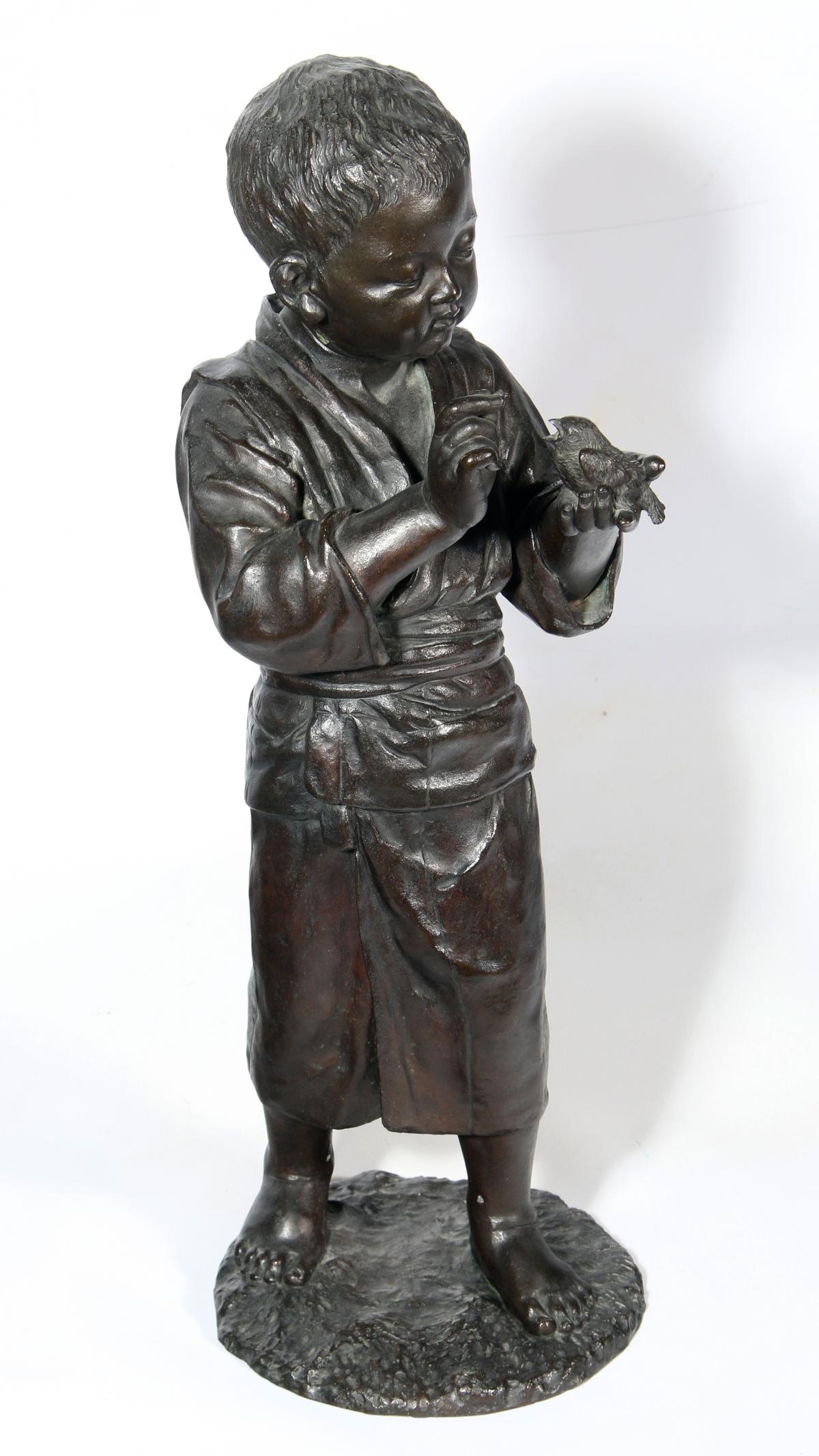 A MEIJI JAPANESE BRONZE FIGURE OF BOY WITH BIRD