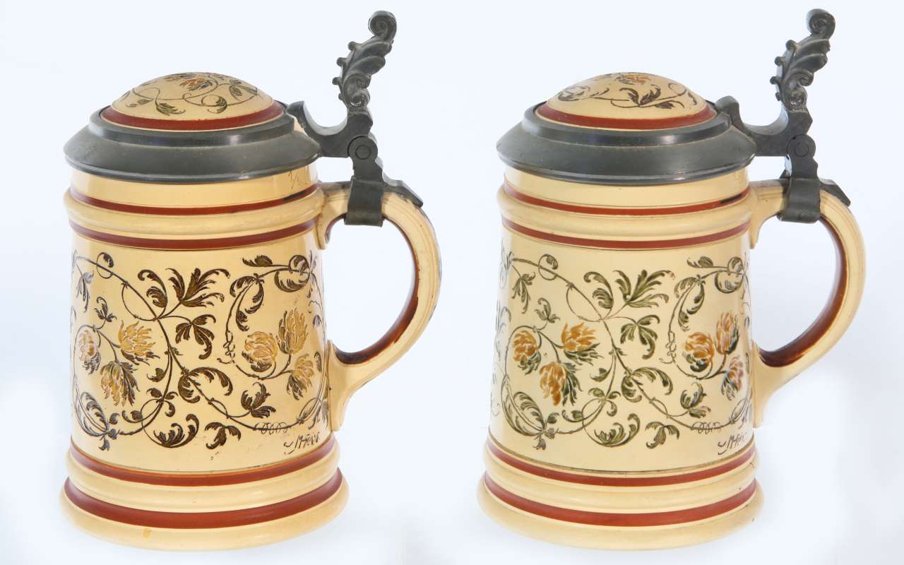 TWO MATCHING METTLACH PAINT UNDER GLAZE STEINS