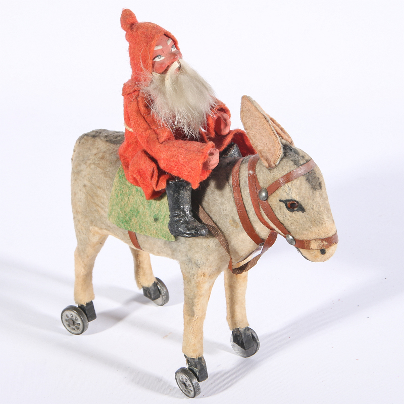 AN UNUSUAL CIRCA 1900 GERMAN SANTA ASTRIDE DONKEY