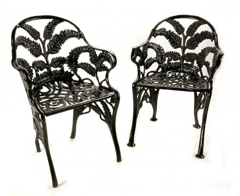 A PAIR CAST IRON FERN PATTERN GARDEN CHAIRS 