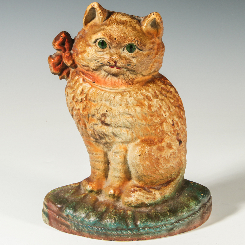 AN ORIGINAL HUBLEY SEATED CAT WITH BOW DOOR STOP