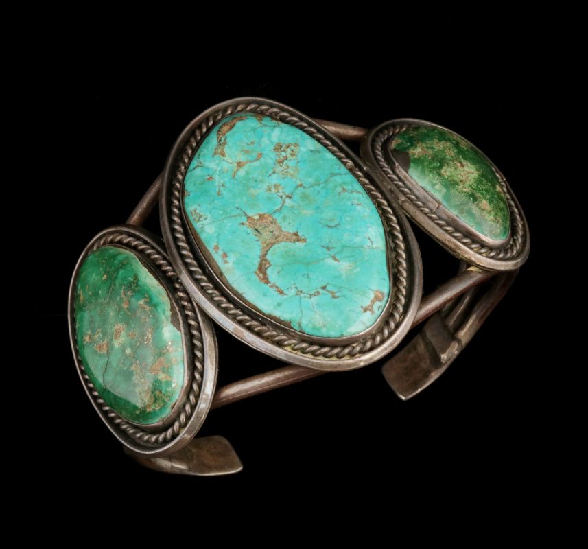 A LARGE STERLING AND TURQUOISE NAVAJO BRACELET