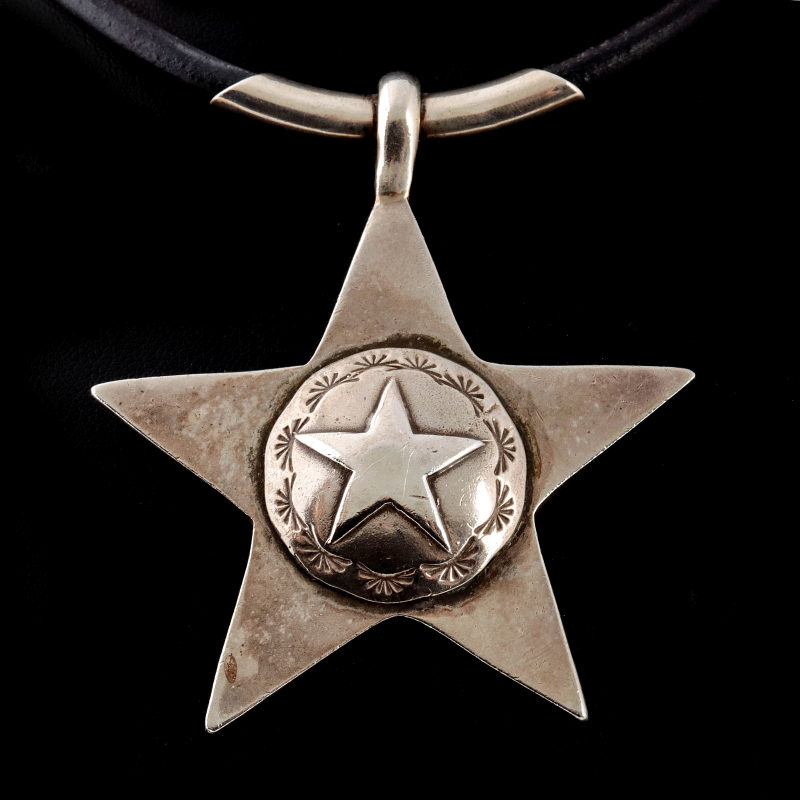 AN ARNOLD GOLDSTEIN STERLING STAR PENDANT