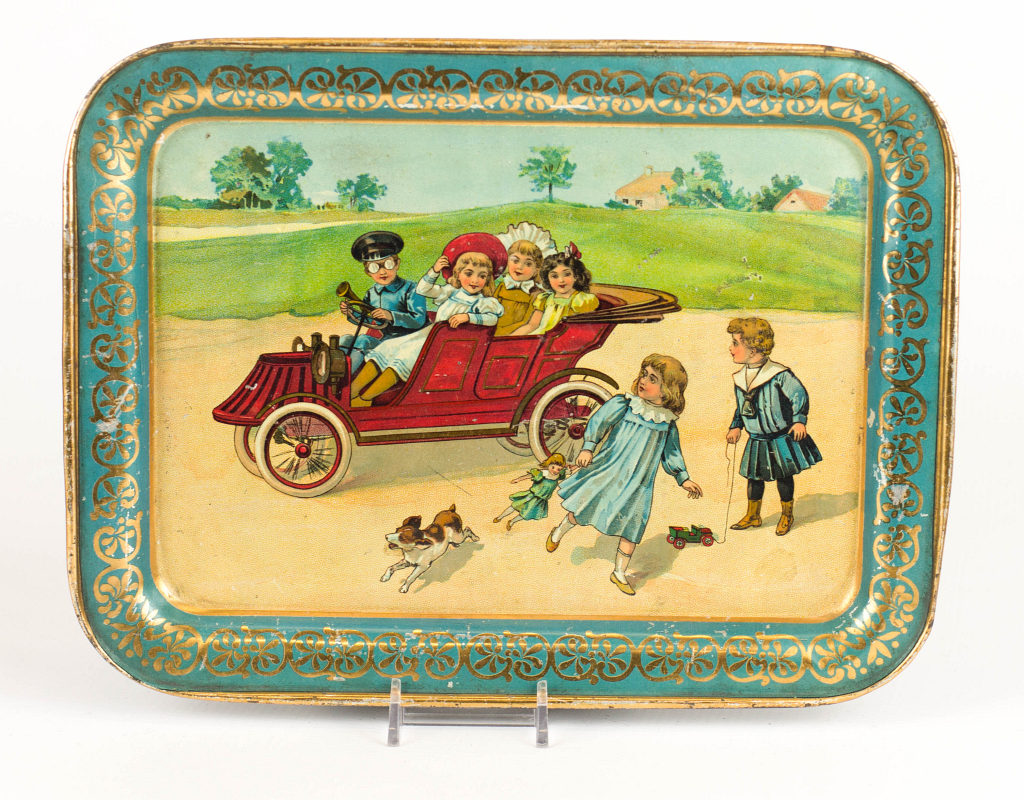 AN EARLY AUTOMOTIVE TIN LITHO CHILD'S TRAY