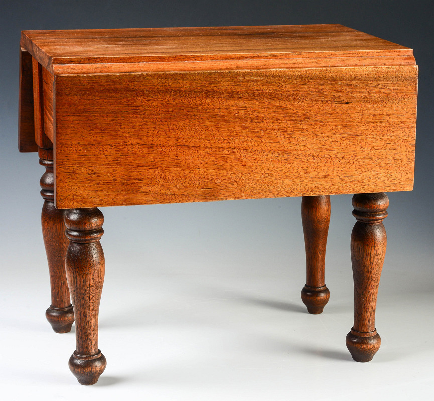 A CHILD'S SIZE WALNUT DROP LEAF TABLE