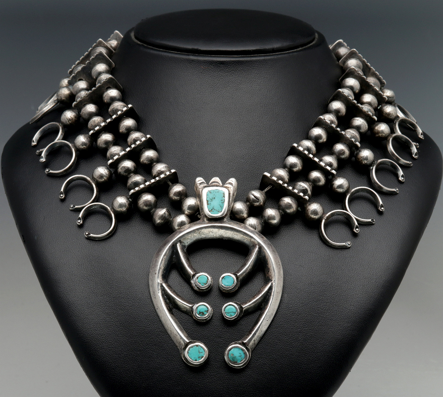 A SQUASH BLOSSOM NECKLACE WITH INLAID TURQUOISE