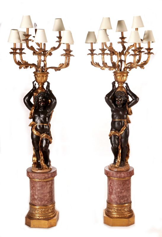 A PAIR 20TH CENTURY BLACKAMOOR PUTTO TORCHIERES 