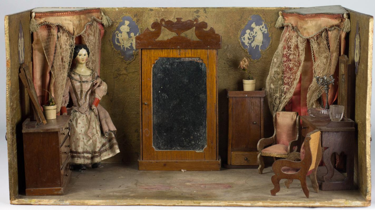 A CIRCA 1850 FRENCH PAPIER MACHE DOLL IN DIORAMA