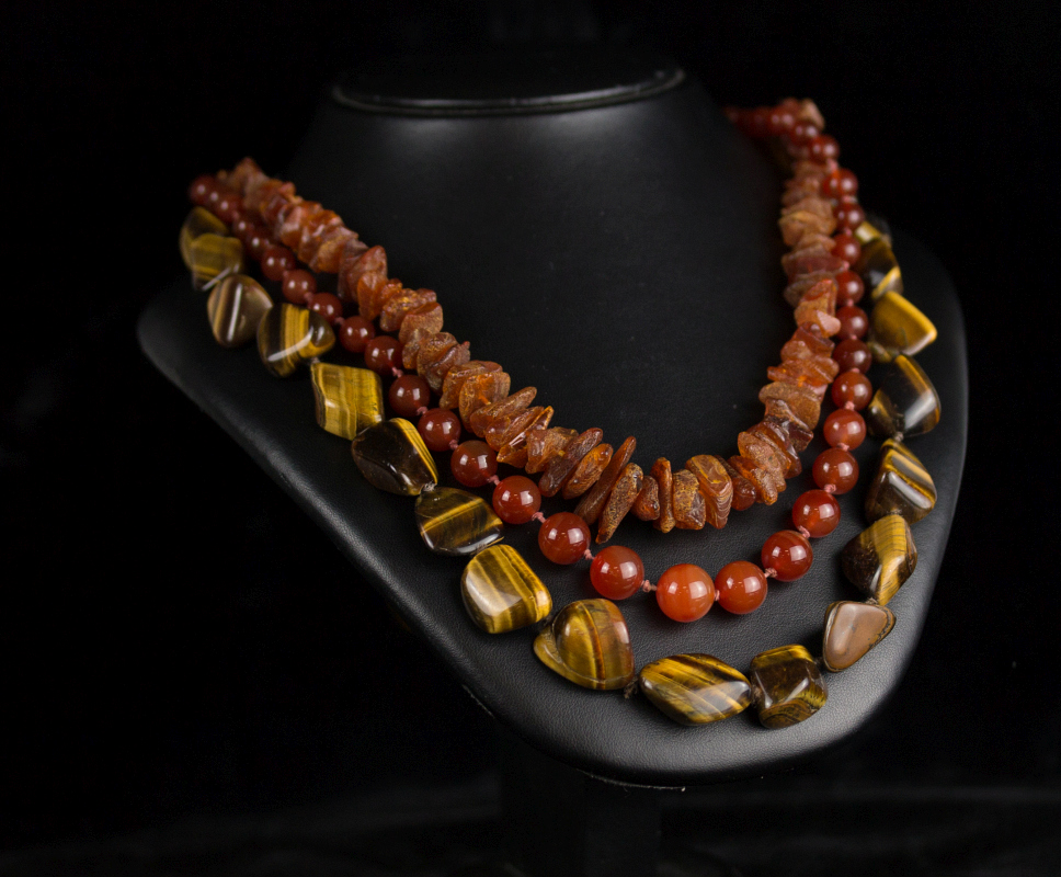 THREE STRANDS OF SEMI-PRECIOUS STONE BEADS 