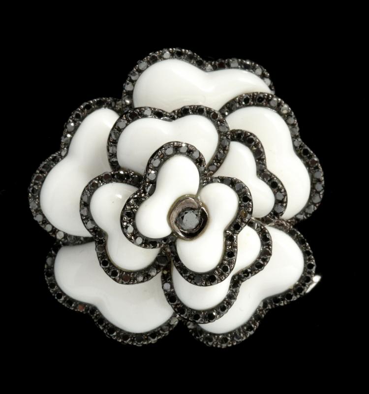 A TIVOL 18K GOLD FLOWER FORM BLACK DIAMOND PIN