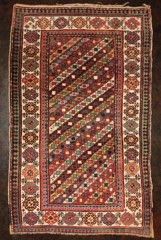 AN ANTIQUE CAUCASIAN GENDJE LONG RUN RUG 