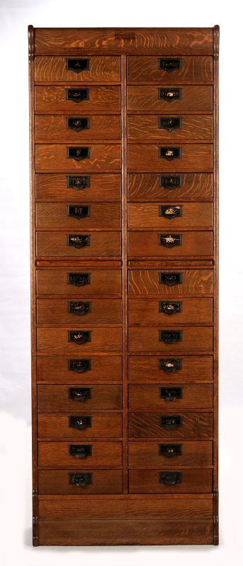 A GLOBE WERNICKE OAK THIRTY DRAWER FILE CABINET