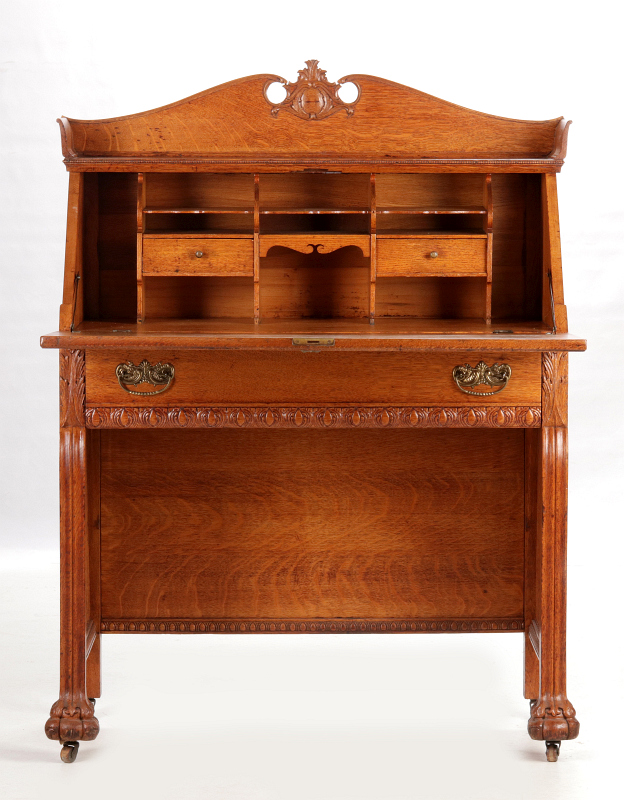 AN UNUSUAL OAK SLANT FRONT KNEE HOLE DESK C. 1890