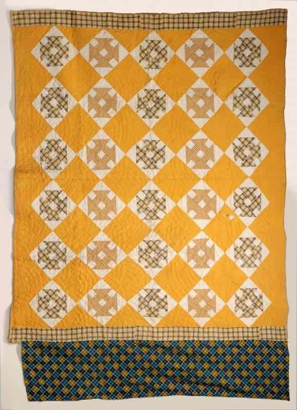 A 'CHURN DASH' PATTERN ANTIQUE QUILT