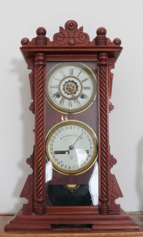 A WATERBURY NO. 40 DOUBLE DIAL CALENDAR CLOCK