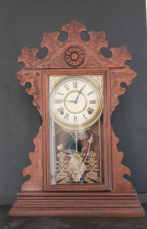 A WALNUT WELCH GINGERBREAD PARLOR CLOCK