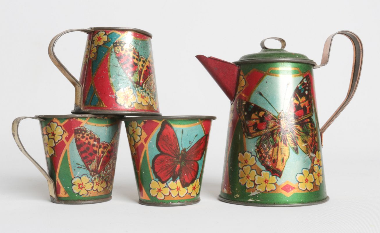 A CHILD'S TIN LITHO TEA SET WITH BUTTERFLIES