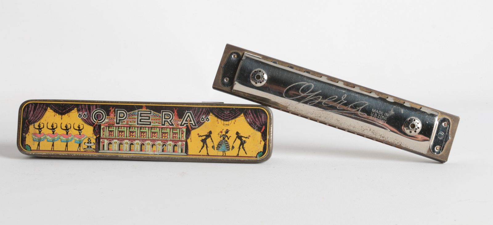 A GERMAN 'OPERA' HARMONICA WITH TIN LITHO CASE