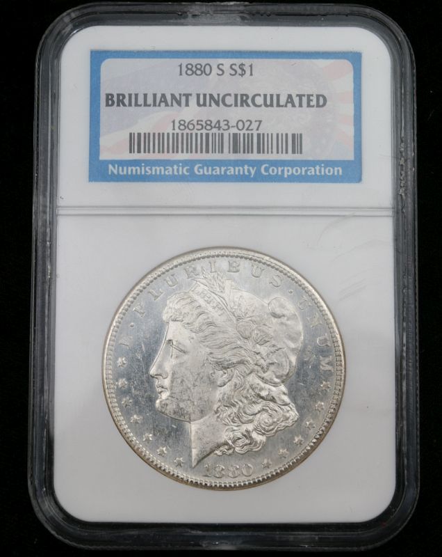 A 1880 S MORGAN SILVER DOLLAR GRADED