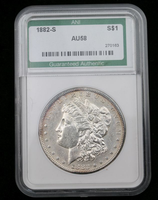 A 1882 S MORGAN SILVER DOLLAR GRADED