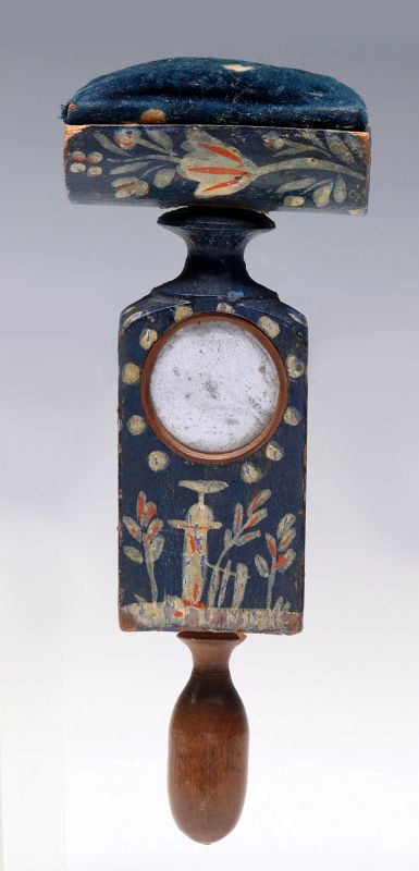 AN ANTIQUE PAINTED SEWING CLAMP PINCUSHION