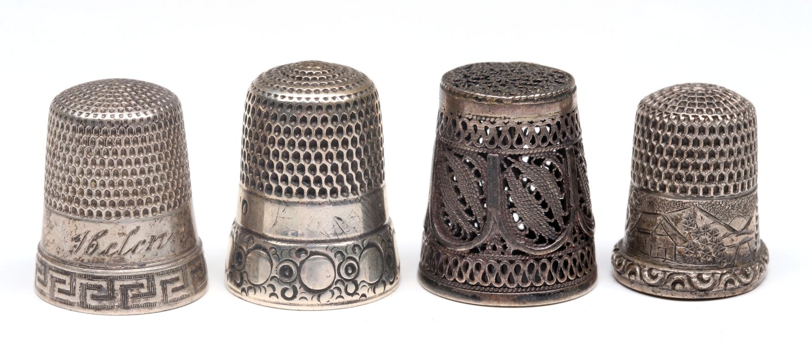 FOUR ANTIQUE STERLING SILVER THIMBLES