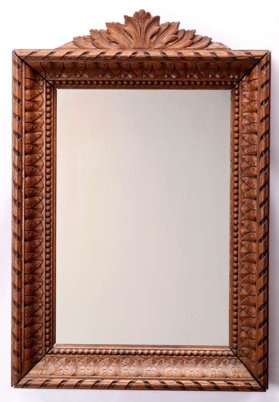 A CIRCA 1900 CARVED OAK MIRROR FRAME