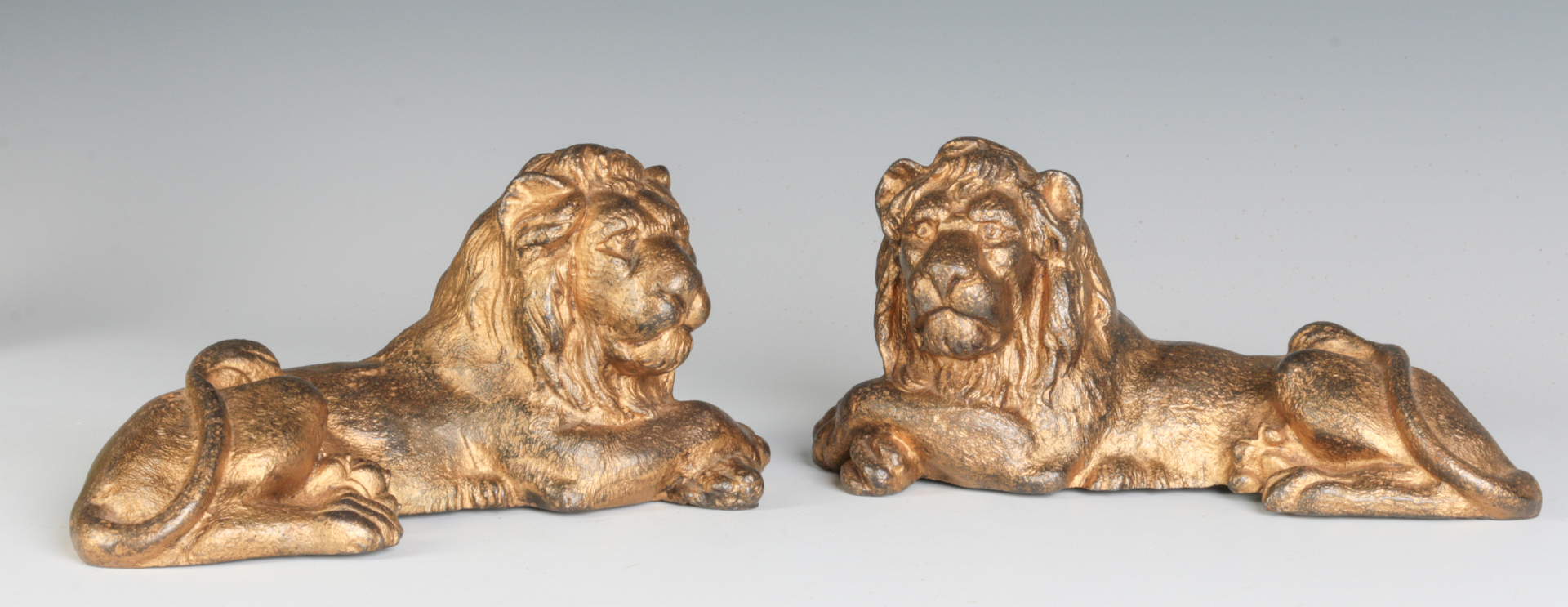 TWO CAST IRON LION FIGURES, OLD GILT PAINT