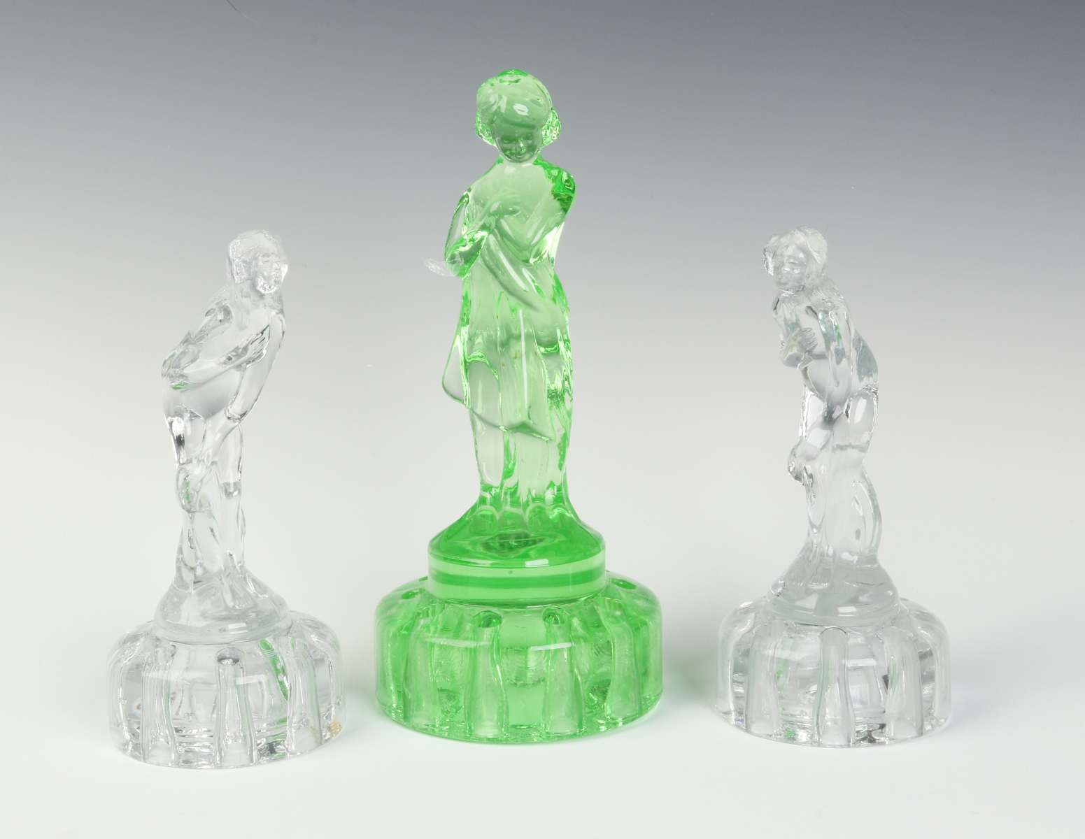 THREE CAMBRIDGE GLASS FIGURAL FLOWER FROGS