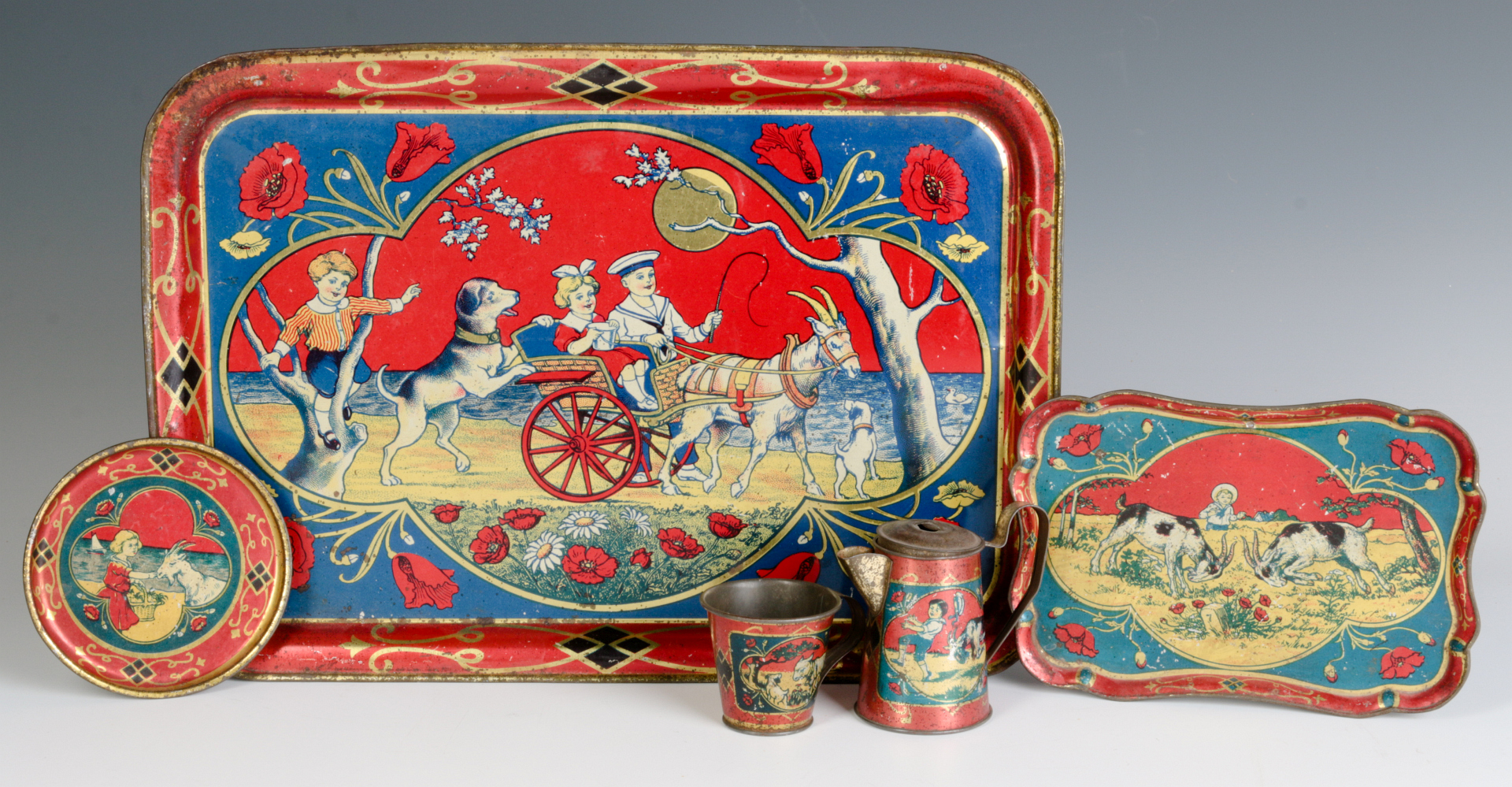 A CHILD'S TIN LITHO TEA SET WITH GOATS & CHILDREN