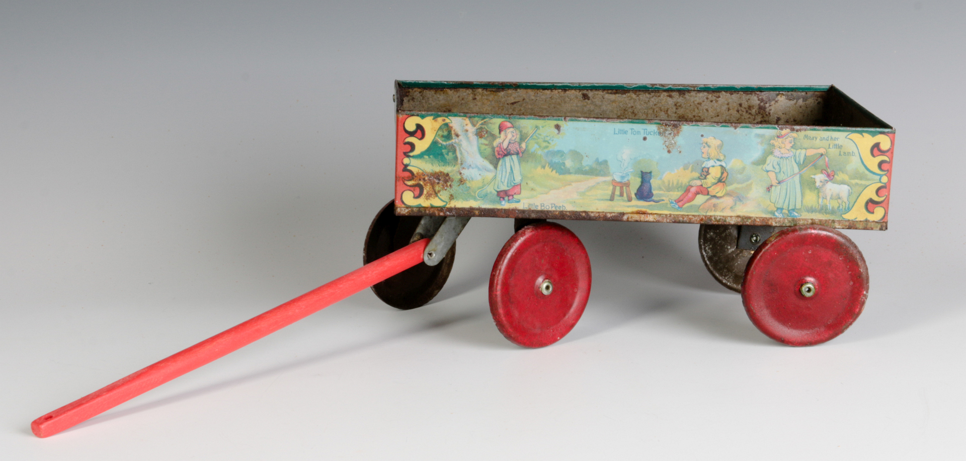 A TIN LITHO CHILD'S DOLL NURSERY RHYME WAGON
