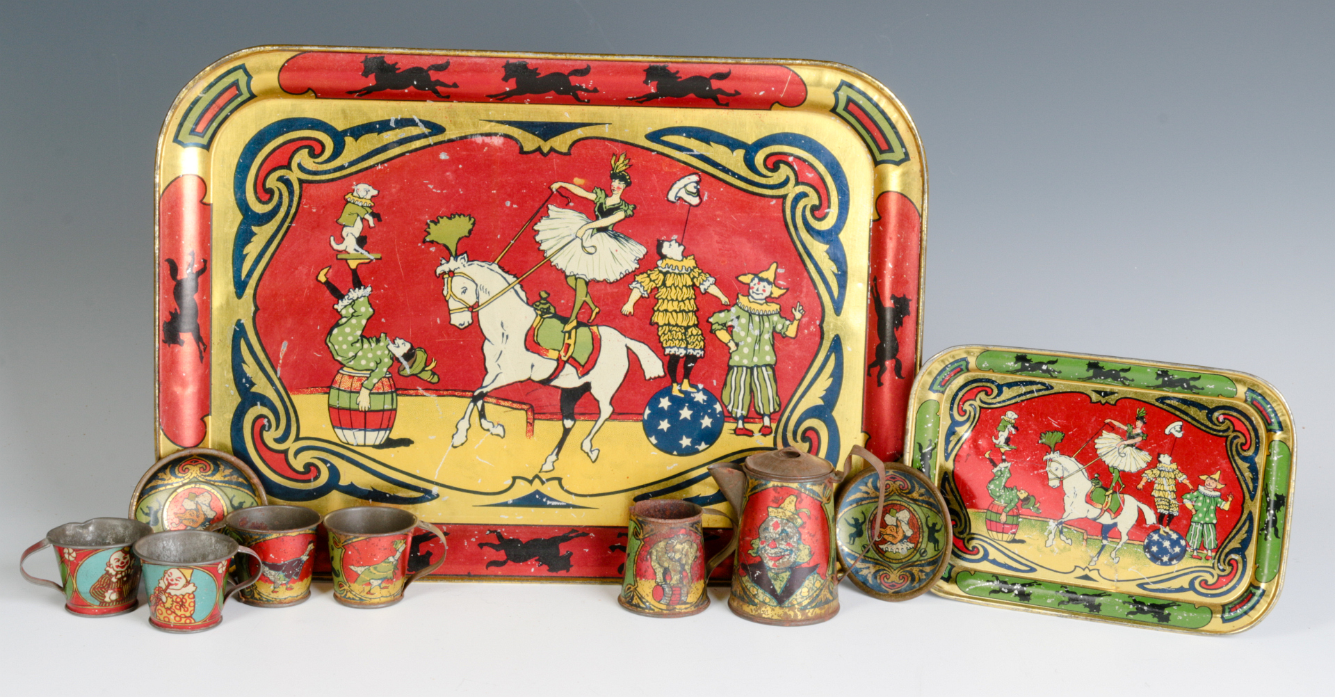 A CIRCUS THEME CHILD'S TIN LITHO TEA SET C. 1920s