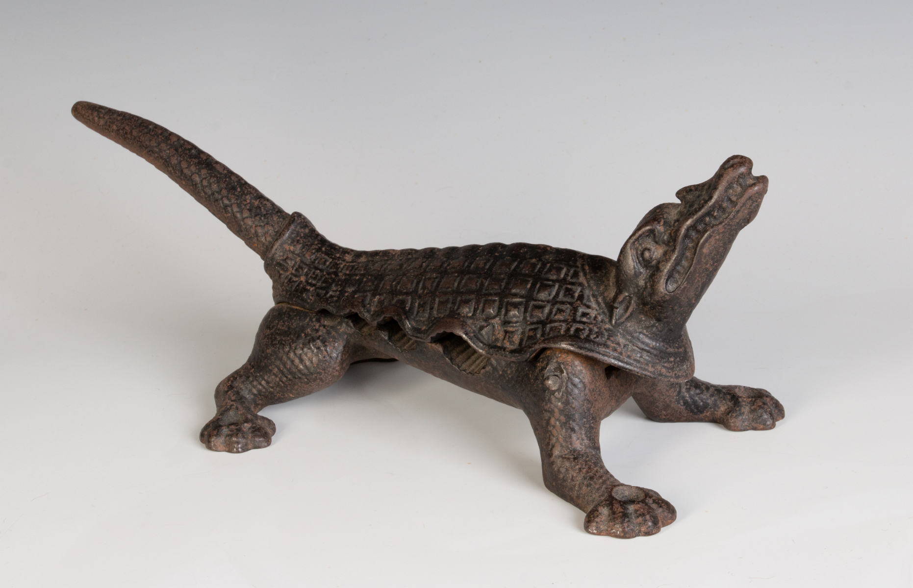 AN ANTIQUE CAST IRON ALLIGATOR CORK PRESS