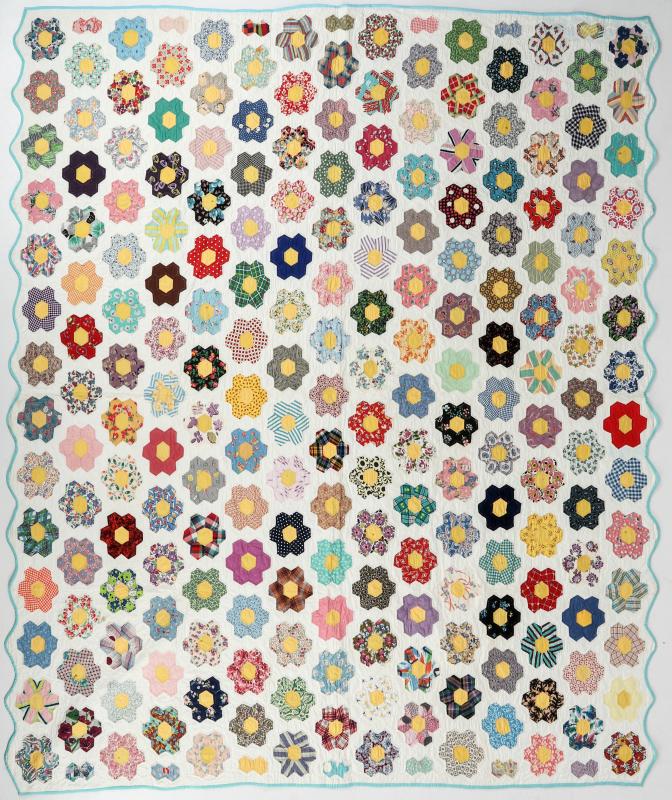 A 'GRANDMOTHER'S FLOWER GARDEN' FEEDSACK QUILT