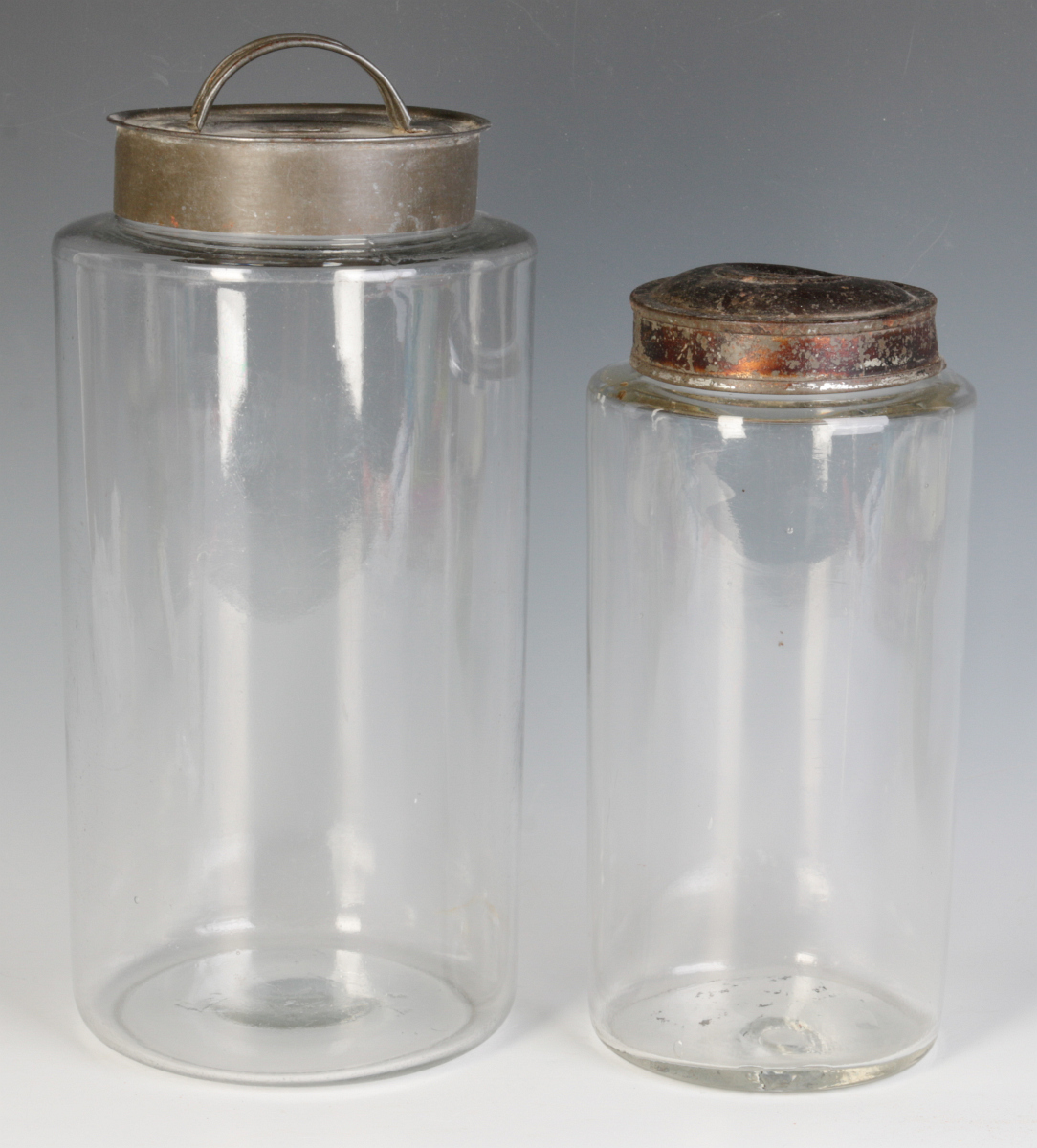 TWO EARLY BLOWN GLASS STORAGE JARS