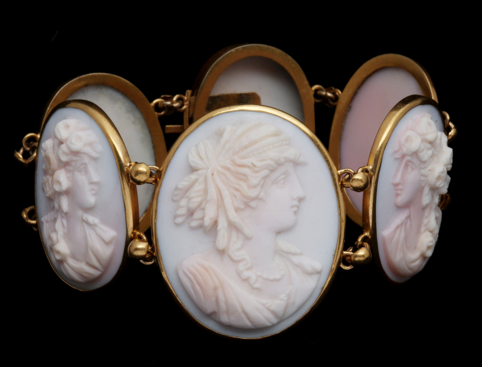 A FINE ANGEL SKIN CARVED CORAL SIX CAMEO BRACELET