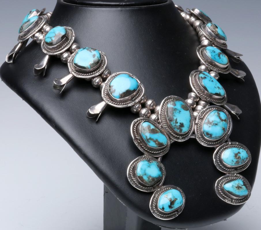 A STERLING AND TURQUOISE SQUASH BLOSSOM NECKLACE